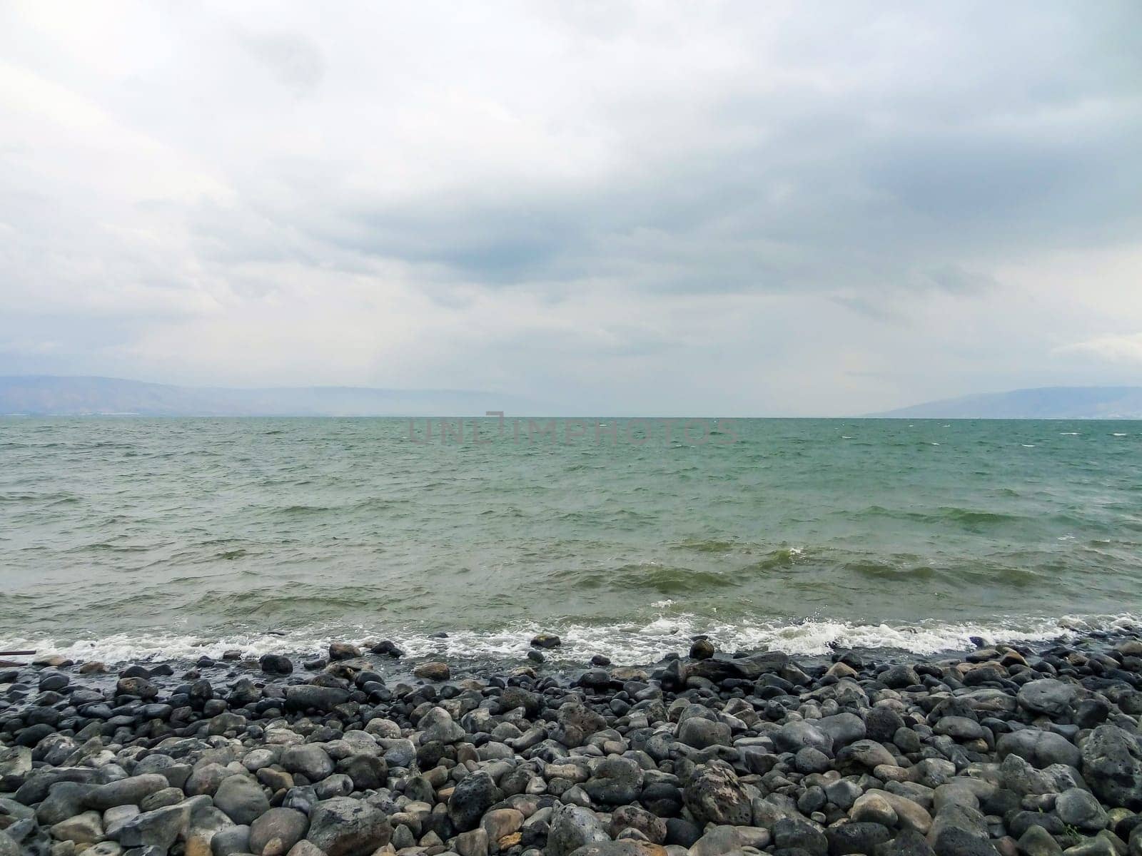 Rocky shore of the sea or lake.The sea of Galilee also called Lake Tiberias or Kinneret, Israel. High quality photo