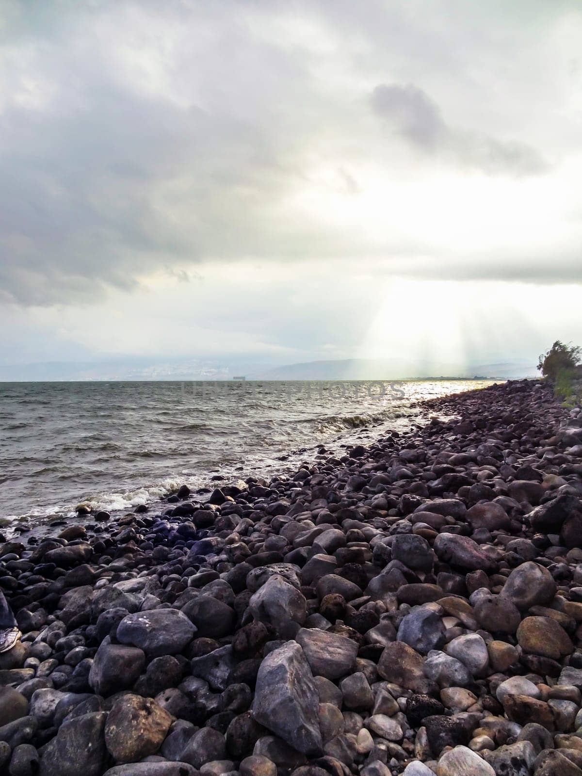 Rocky shore of the sea or lake.The sea of Galilee also called Lake Tiberias or Kinneret, Israel. High quality photo