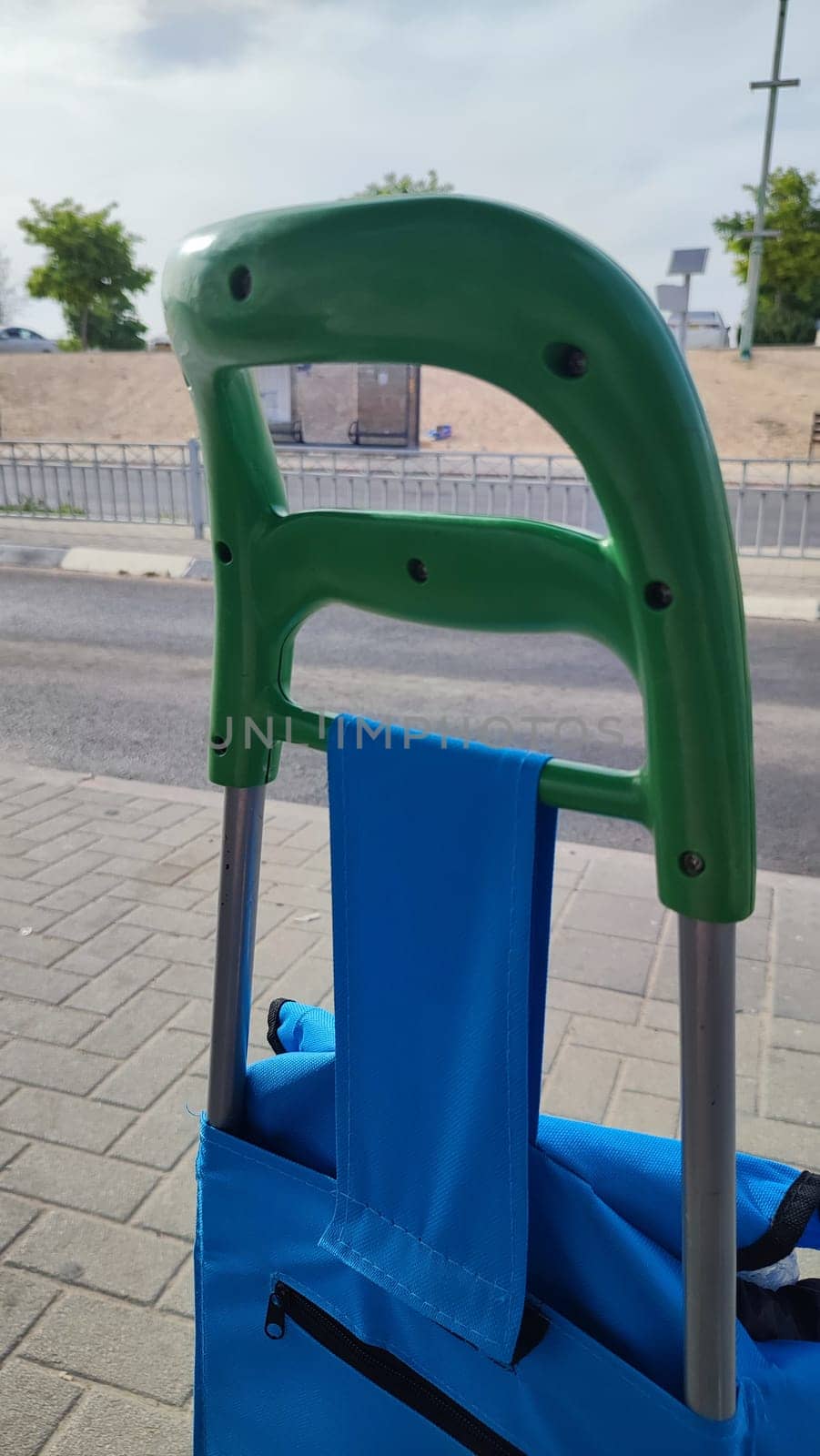 blue cart with green handle for groceries,object. High quality photo