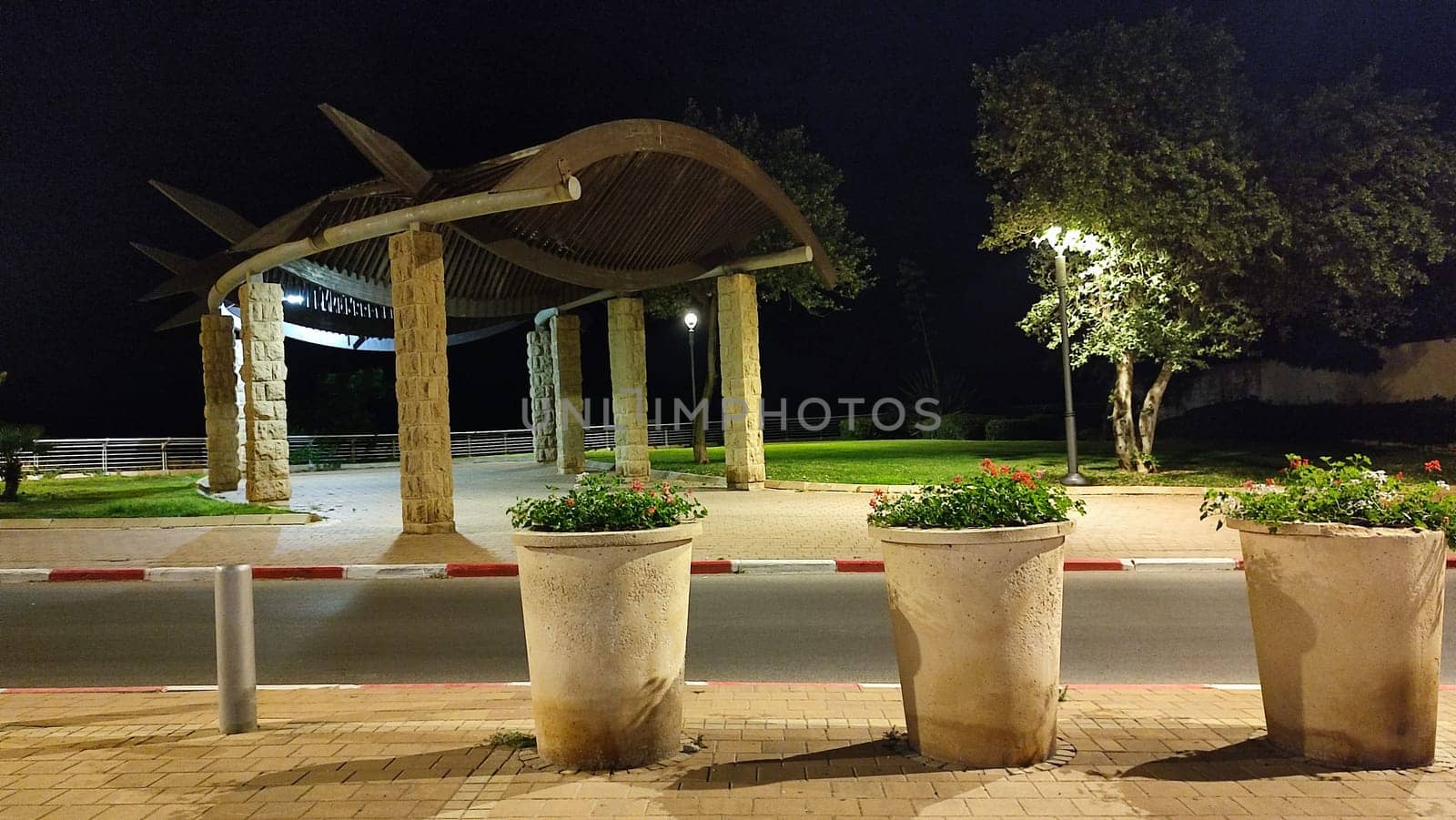 large flower vases outdoors in the city, night decorative landscaping. High quality photo
