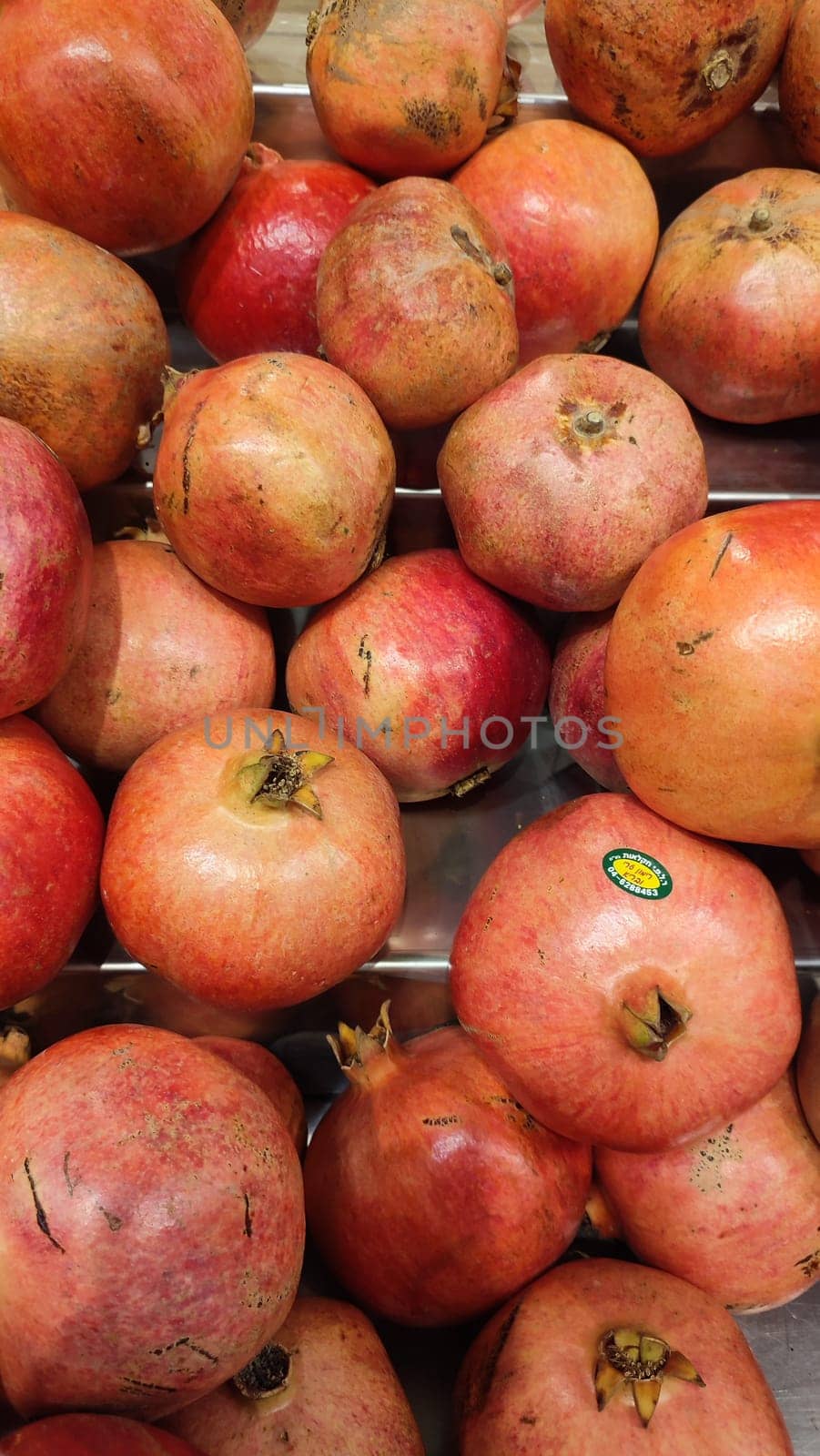 red pomegranate fruit, food background, shop, on sale, grocery store, market High quality photo