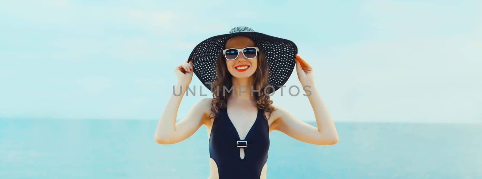 Summer vacation, beautiful happy smiling woman in bikini swimsuit and straw hat on the beach at sea by Rohappy