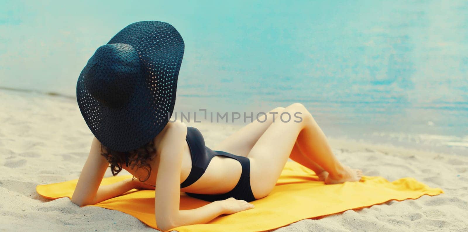 Summer vacation, happy relaxing young woman with straw hat lying on sand on the beach at sea by Rohappy