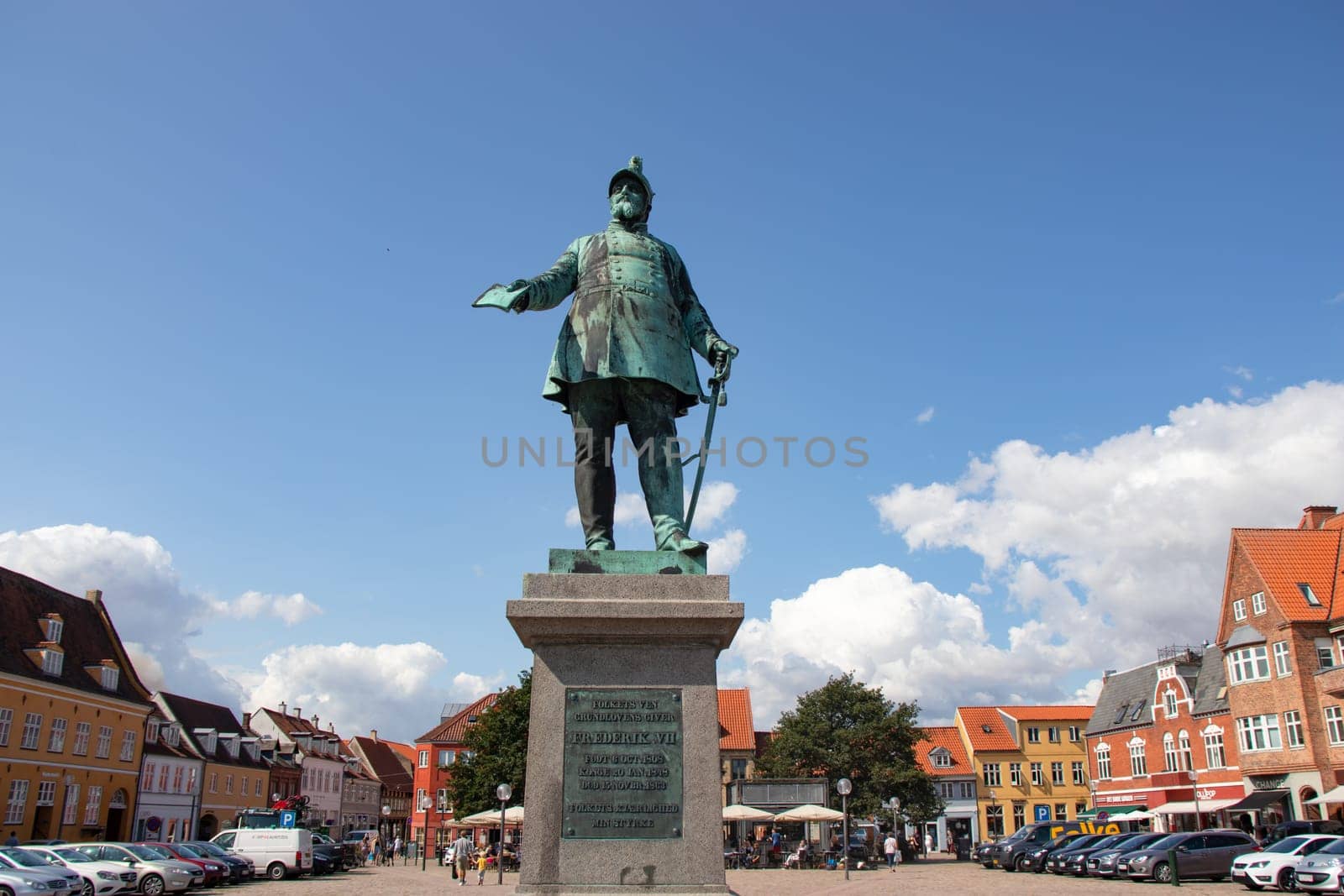 Koge, Denmark - May 1, 2023. City square with a monument to the Danish king Frederick VII. Old houses in Koge Town Centre.