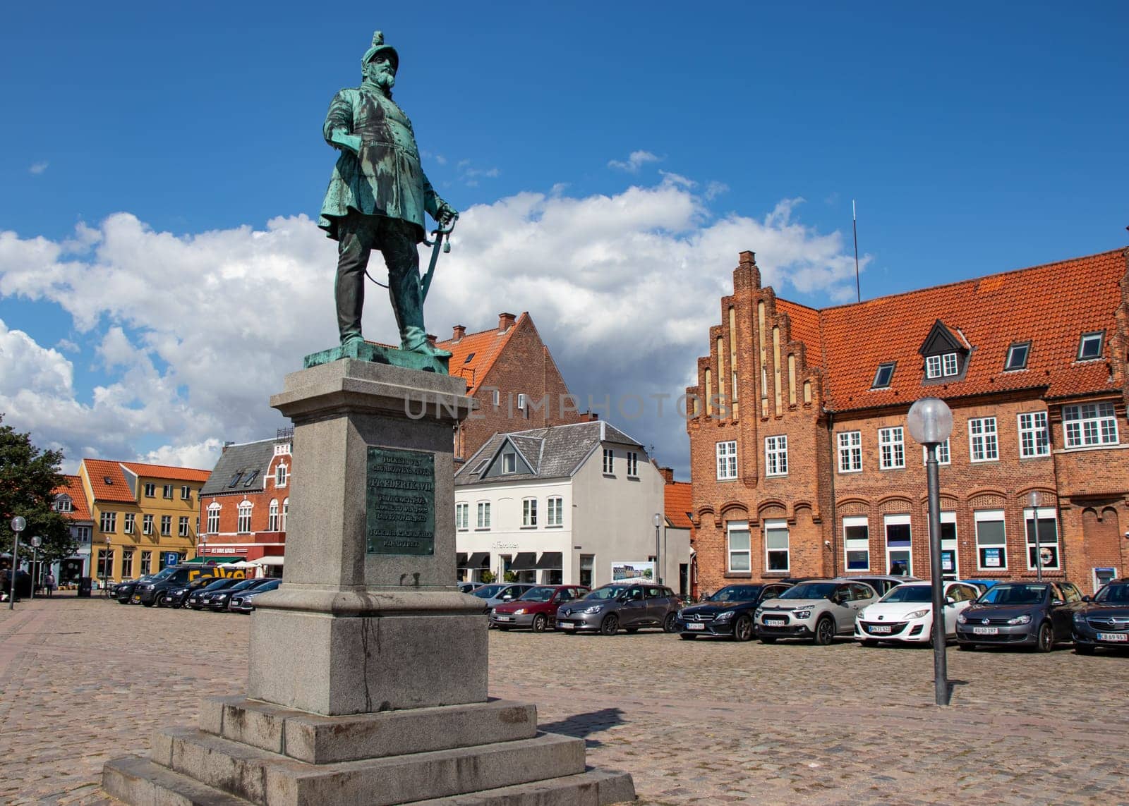 Koge, Denmark - May 1, 2023. City square with a monument to the Danish king Frederick VII. Old houses in Koge Town Centre. High quality photo