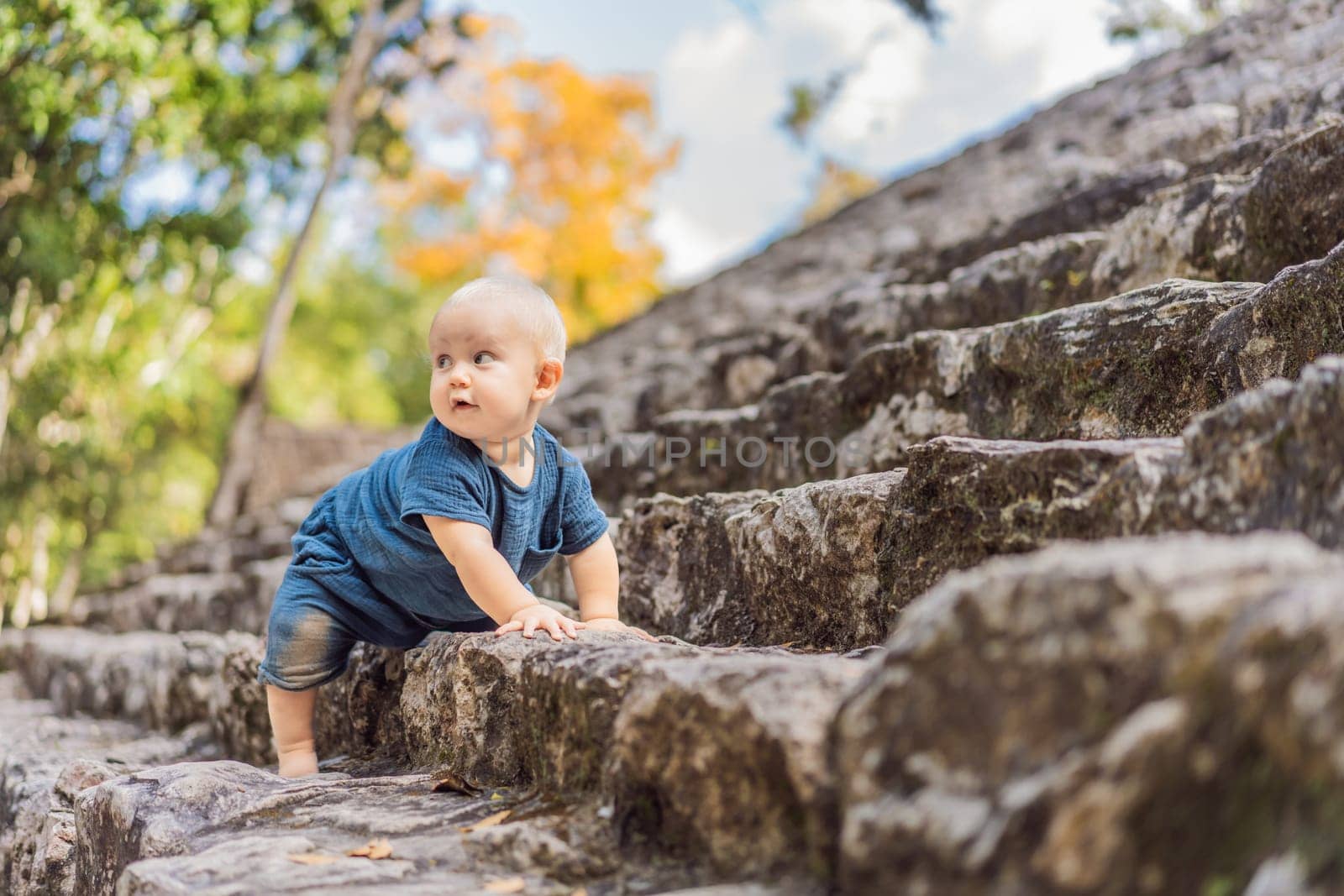 Baby tourist at Coba, Mexico. Ancient mayan city in Mexico. Coba is an archaeological area and a famous landmark of Yucatan Peninsula. Cloudy sky over a pyramid in Mexico by galitskaya