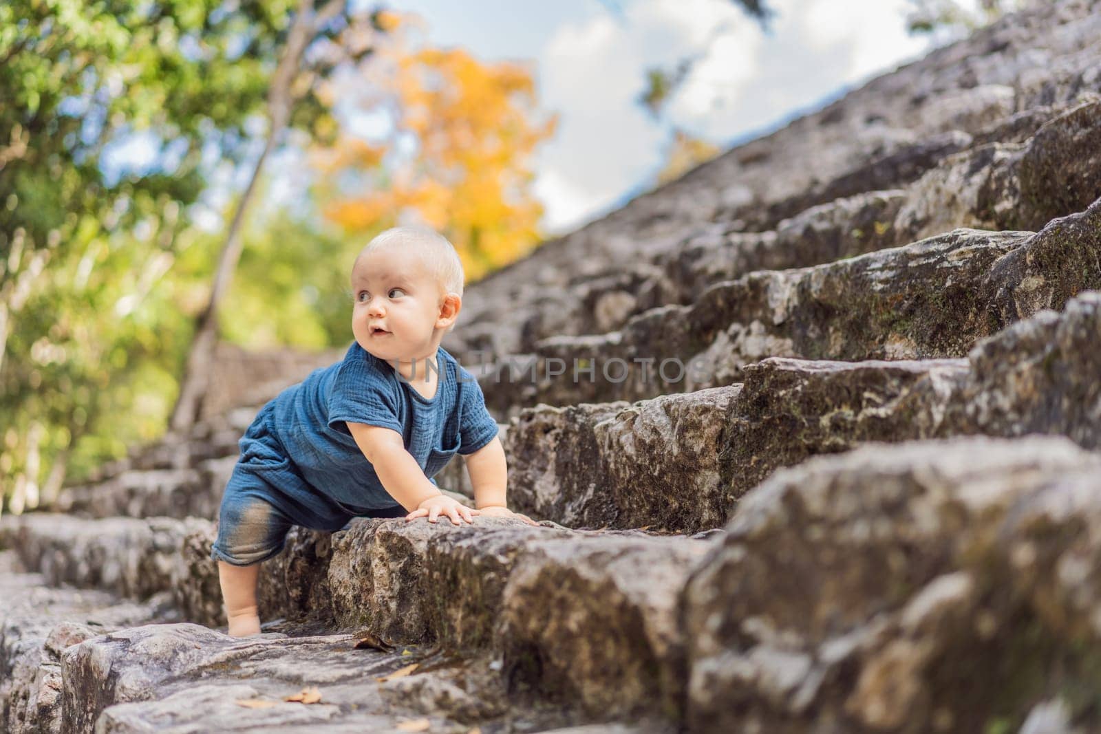 Baby tourist at Coba, Mexico. Ancient mayan city in Mexico. Coba is an archaeological area and a famous landmark of Yucatan Peninsula. Cloudy sky over a pyramid in Mexico.