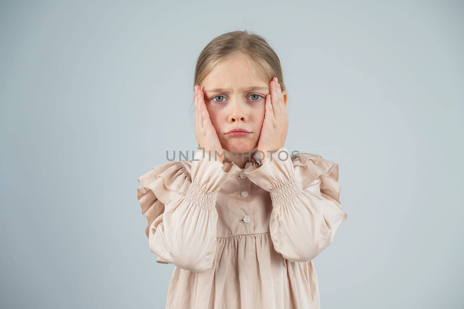 Portrait of a dissatisfied Caucasian girl on a white background