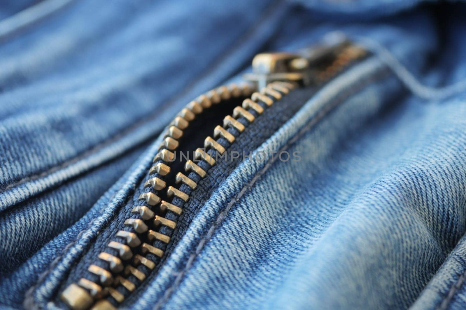 Closeup of metal zipper on denim jeans,