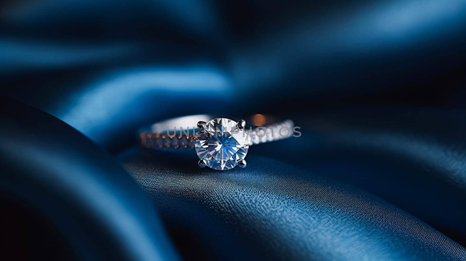 Jewellery, proposal and holiday gift, diamond engagement ring on blue silk fabric, symbol of love, romance and commitment by Anneleven