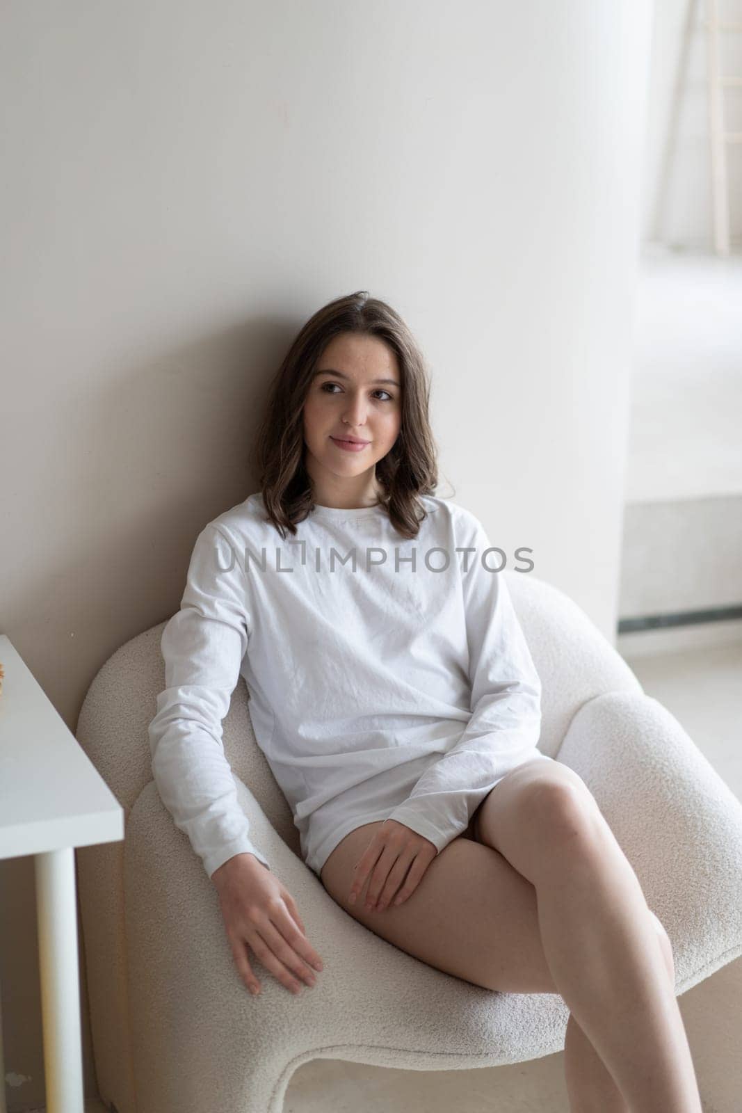 young beautiful woman posing in white lingerie in studio