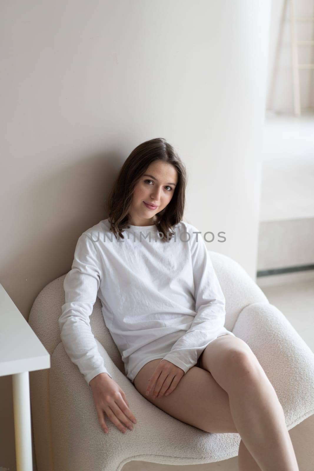 young beautiful woman posing in white lingerie in studio