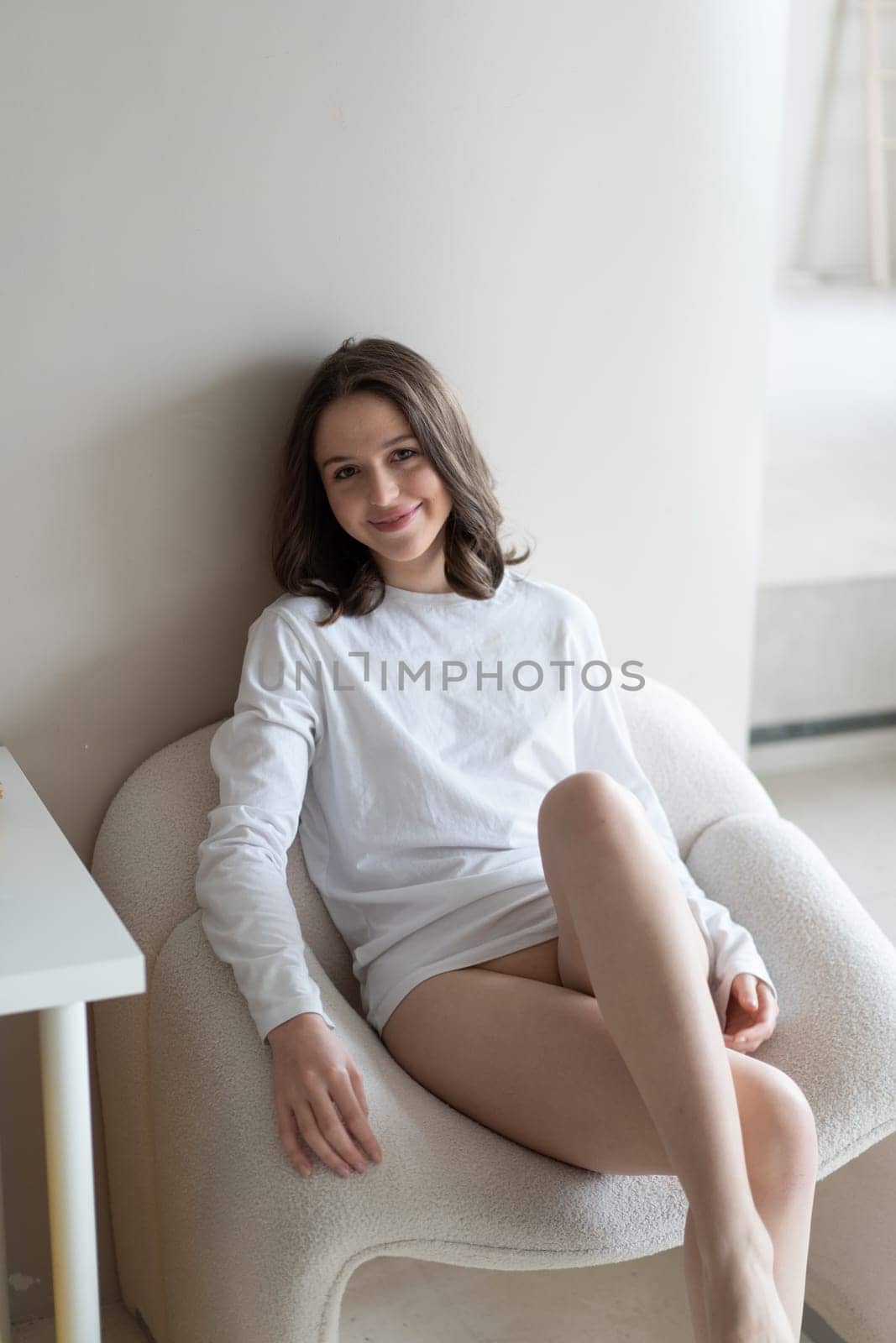 young beautiful woman posing in white lingerie in studio