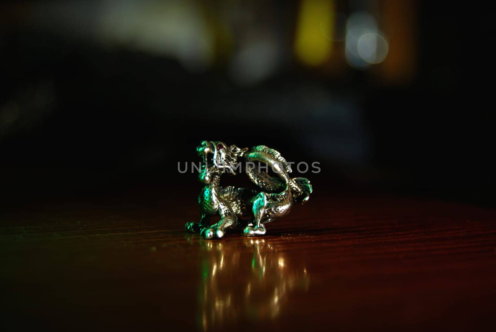 Dragon figurine with beautiful reflection and bokeh effect.