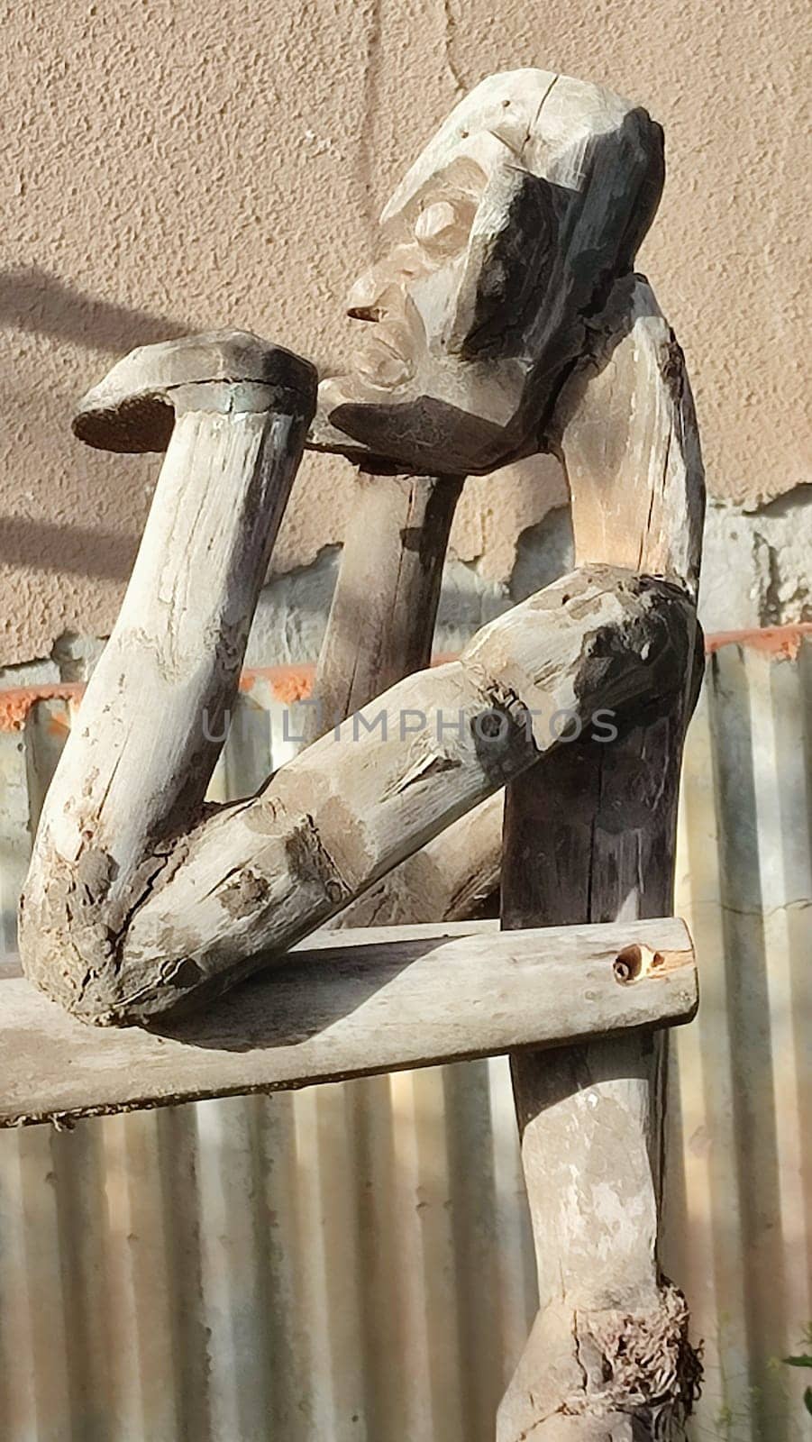 wooden sculpture of a man street art. High quality photo
