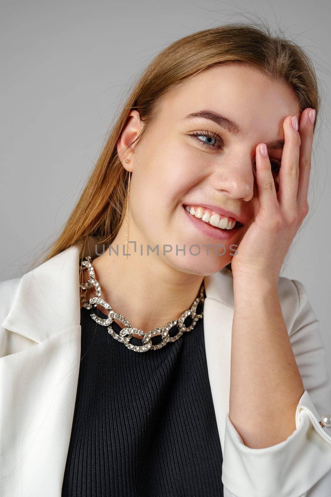 Young Woman Smiling and Holding Hand to Face