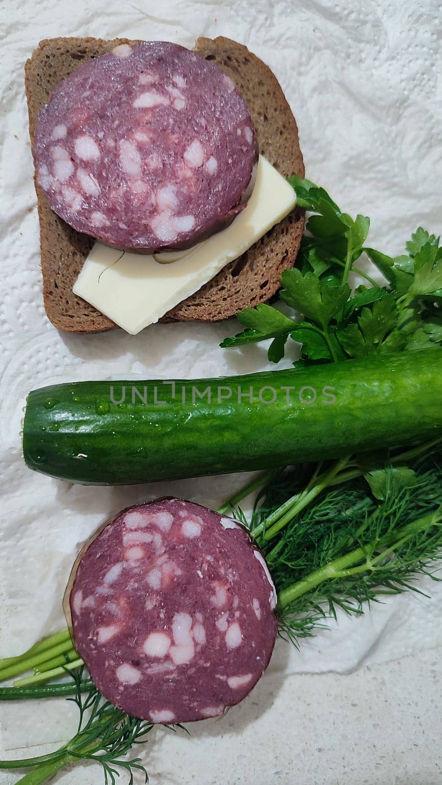dry smoked sausage, sandwich with butter, green fresh cucumber vegetable, parsley food lunch dinner cooking, breakfast. High quality photo