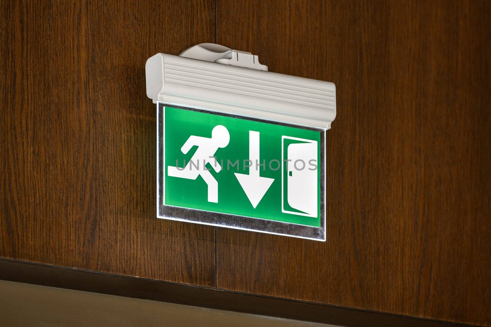 modern emergency exit sign showing emergency exit downwards