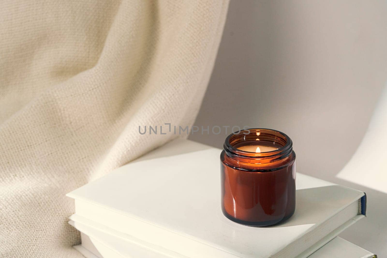 Aromatic candle in glass jar close up photo