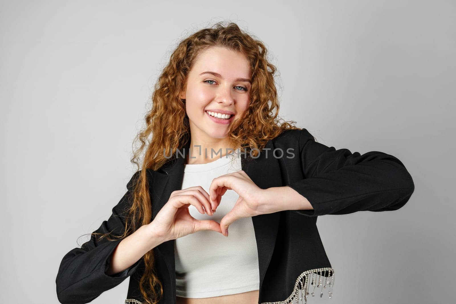 Woman Making Heart With Hands in Studio close up