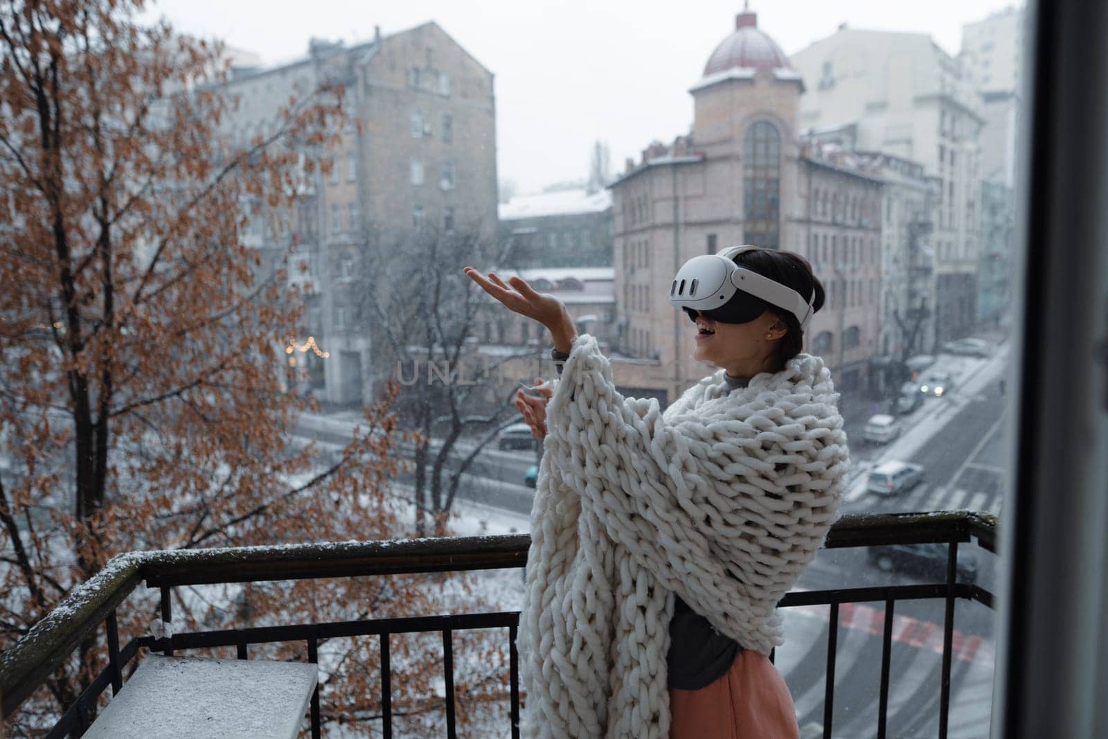 Virtual reality meets the winter city as a girl wears VR glasses against its backdrop. High quality photo