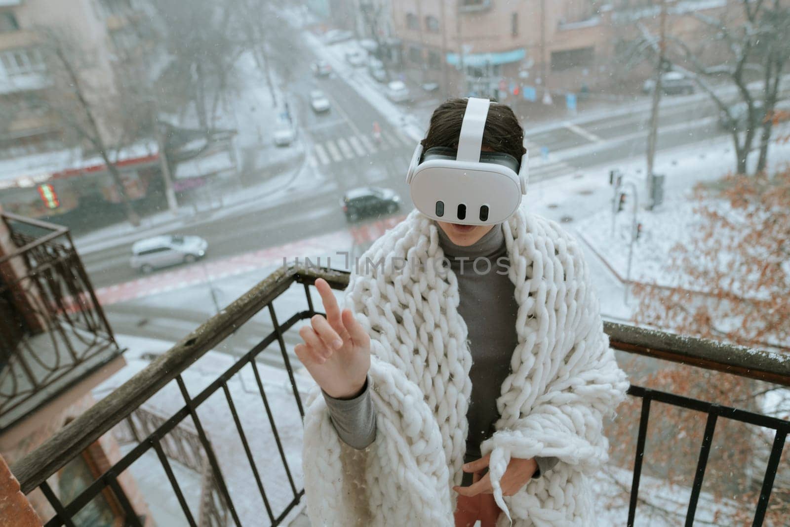 A girl immerses herself in virtual reality on the winter balcony, wearing a headset. by teksomolika