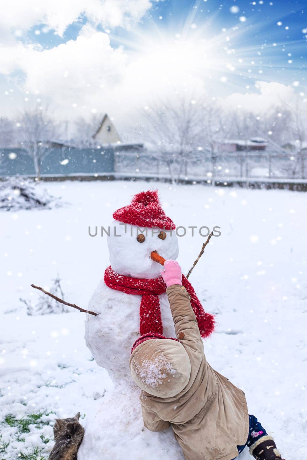 Children make a snowman in winter. Selective focus. Kid.