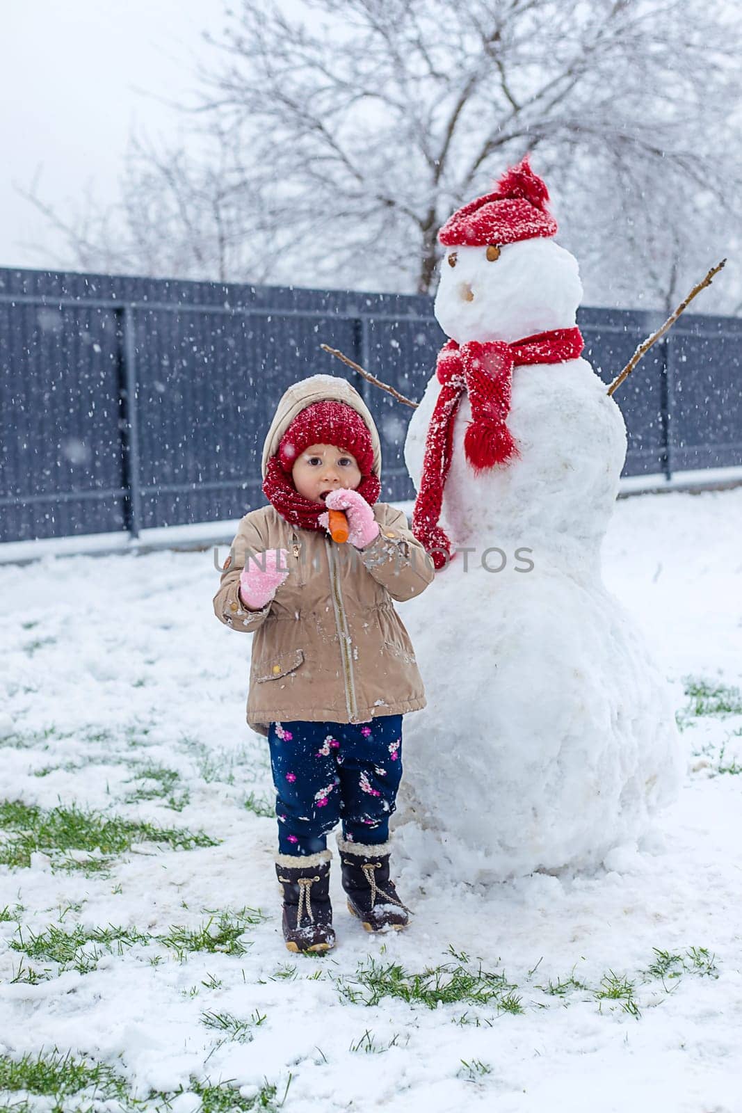 Children make a snowman in winter. Selective focus. Kid.