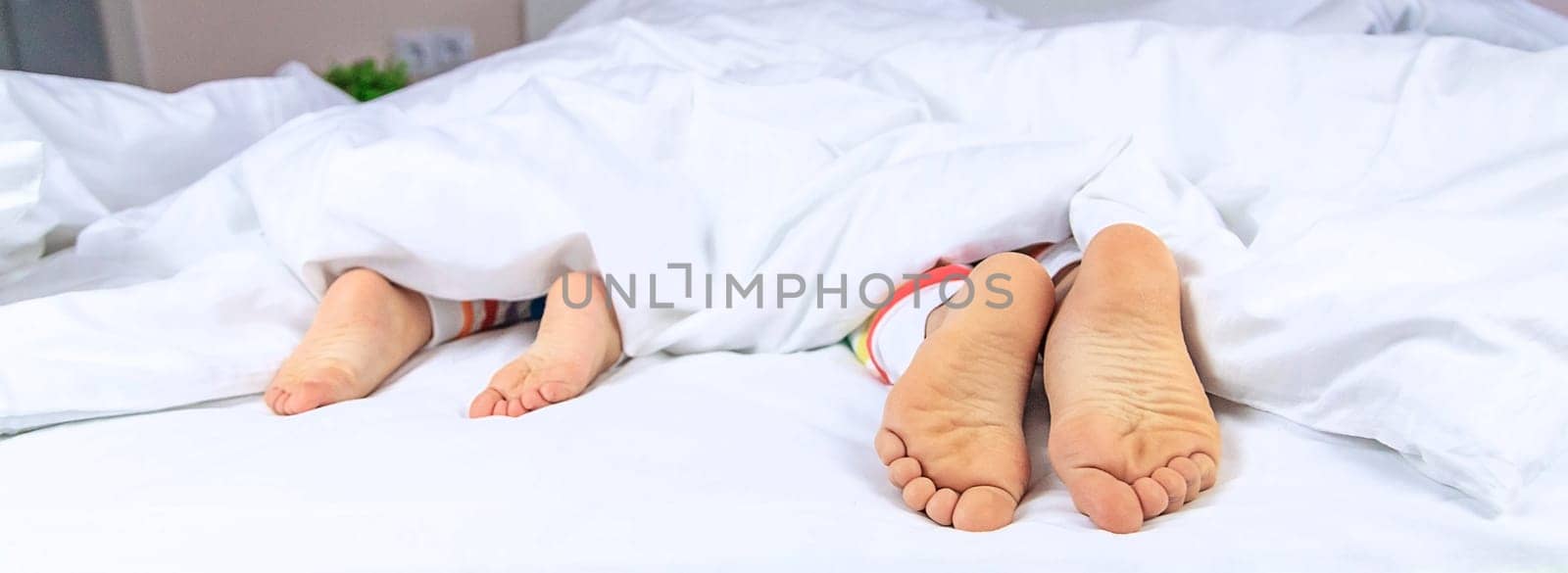 Feet of children in bed. Selective focus. Kids.