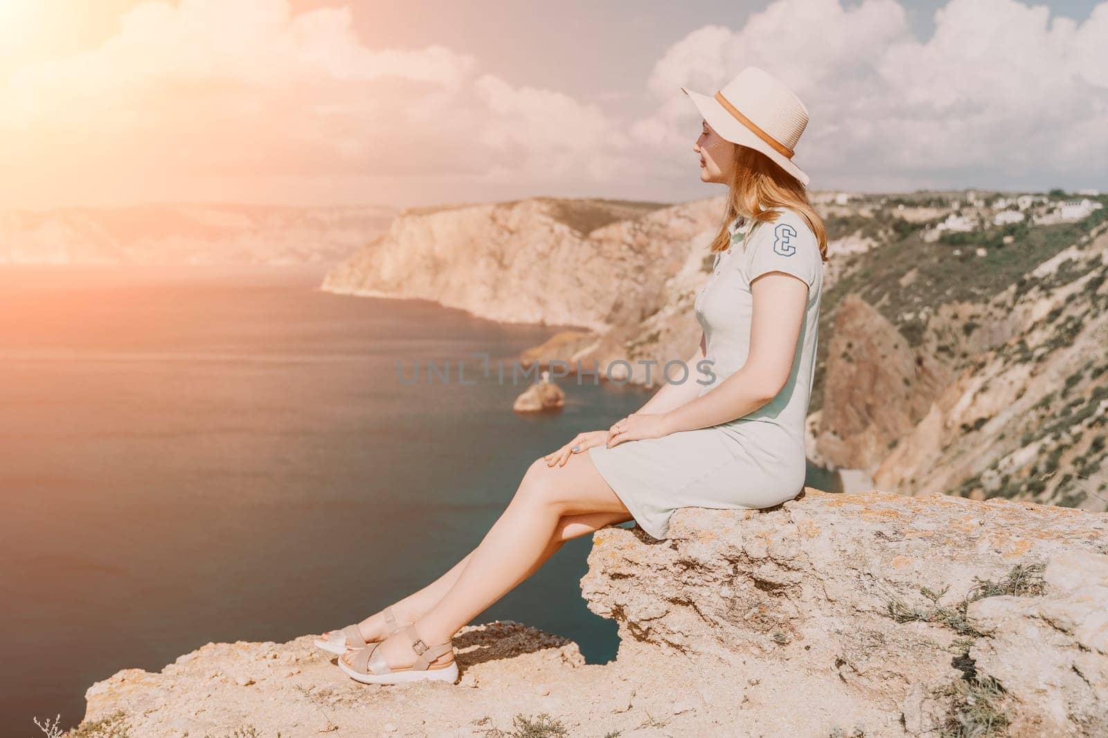 Woman travel sea. Happy carefree sensual woman with long hair in black swimwear posing at sunset beach. Silhouette of young beautiful playful positive woman outdoor. Summer vacation and trip concept