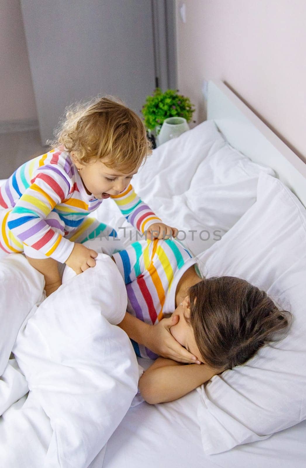 Children play jumping in bed. Selective focus. Kid.