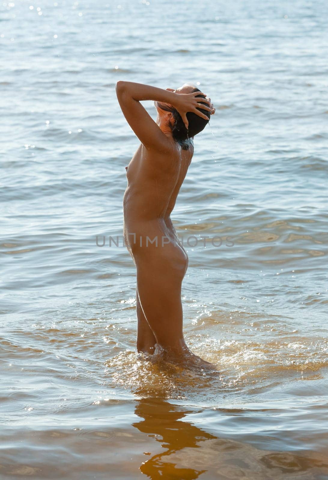 Young beautiful woman posing nude on the seaside by palinchak
