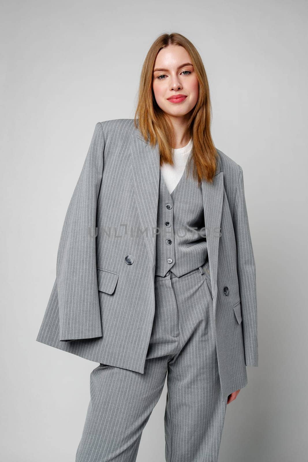 Woman in Gray Suit and White Shirt posing in studio by Fabrikasimf