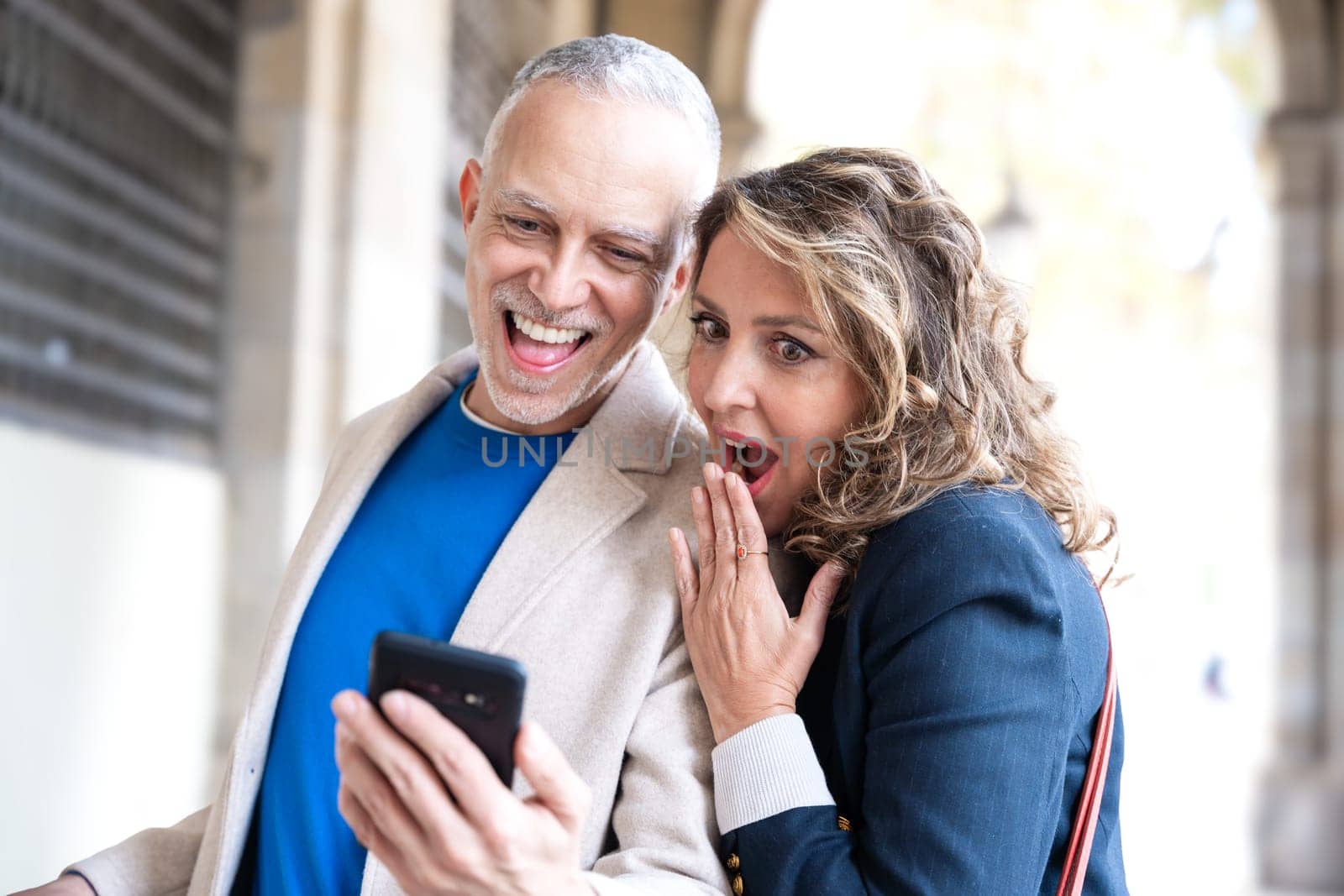 Traveler adult couple using smartphone or mobile phone to search information about hotels, shopping malls and transportation guides on the app. lifestyle and travel concept.