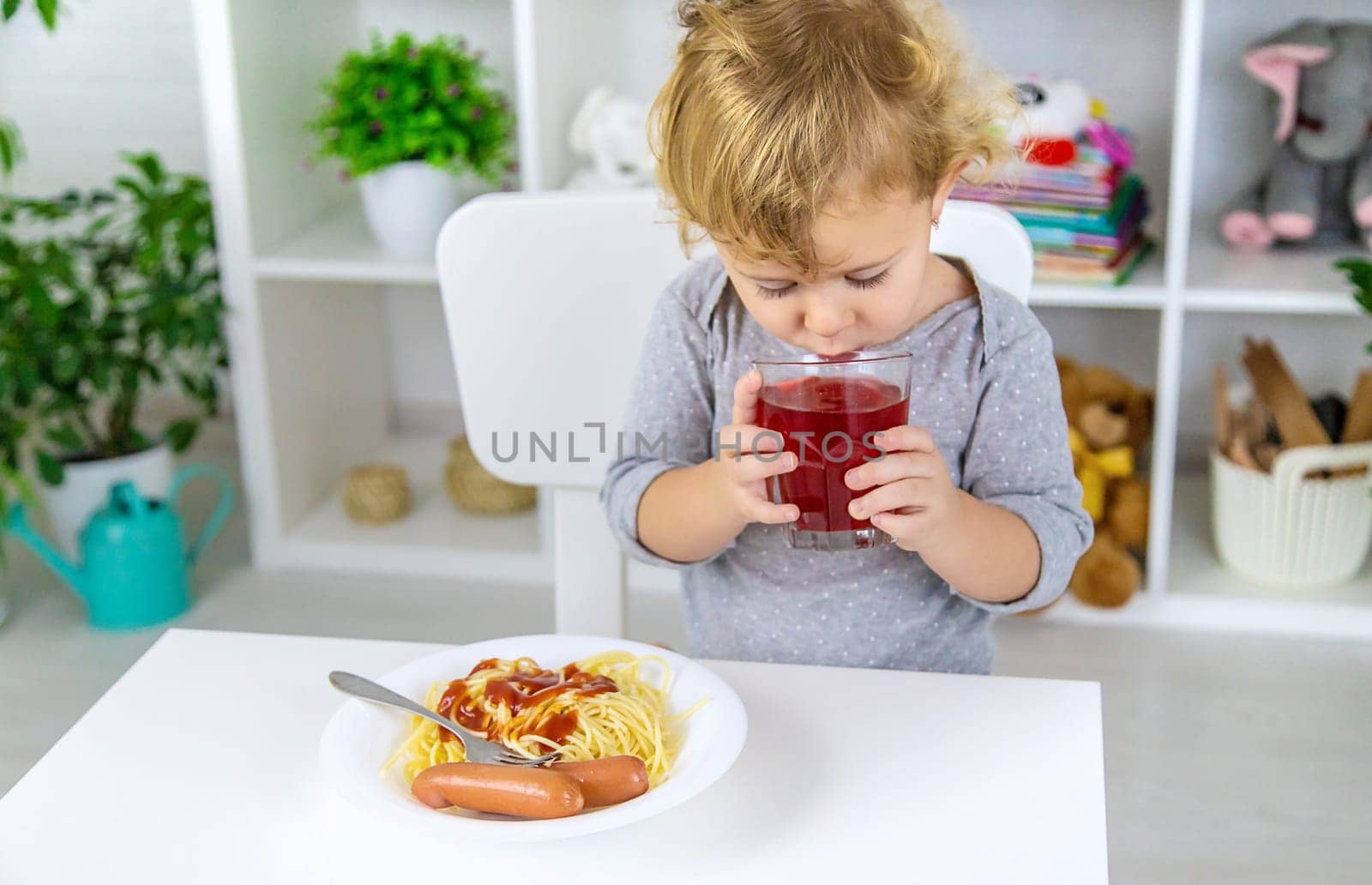 The child eats spaghetti lunch. Selective focus. Food.