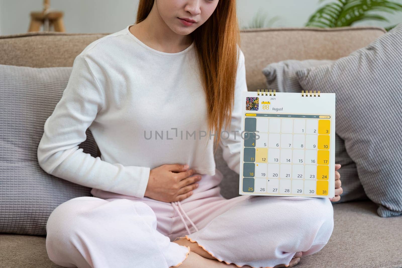 Contraception, menstruation and pregnancy concept, birth control pills asian young woman holding hormonal oral contraceptive pills with calendar, menstrual cycle. Prevention, safe virus sex disease.