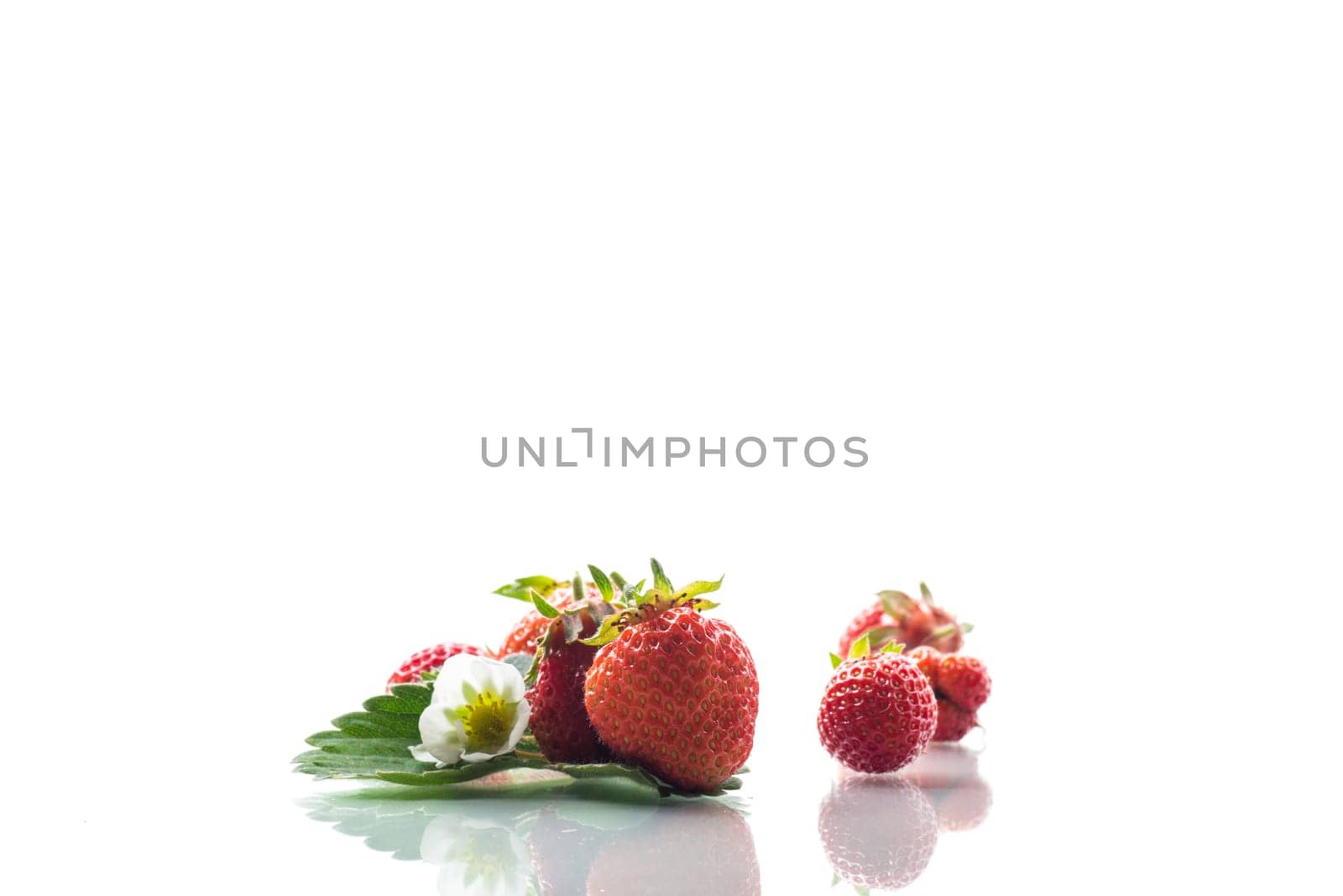 red ripe strawberry spring on a white background .