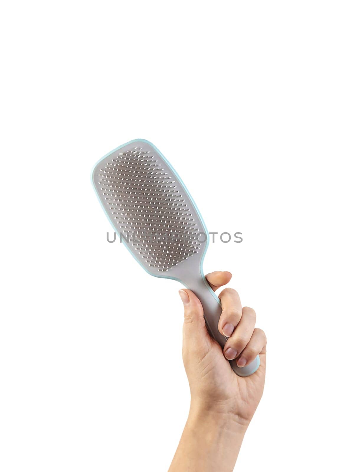 Comb in the hands of a woman isolate. Selective focus. White.