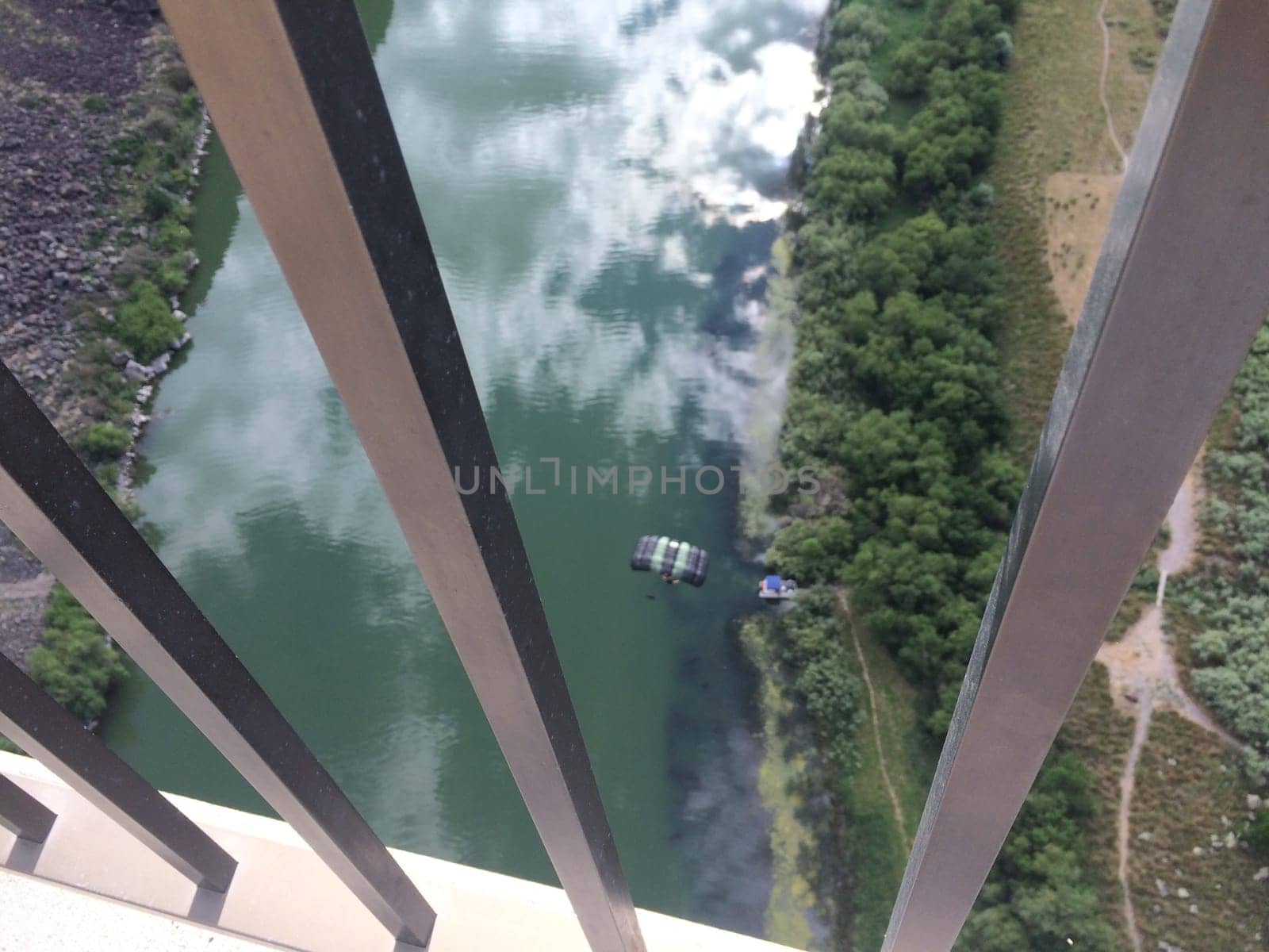 Looking through the Bars of Perrine bridge at a BASE Jumper in Twin Falls, Idaho. High quality photo