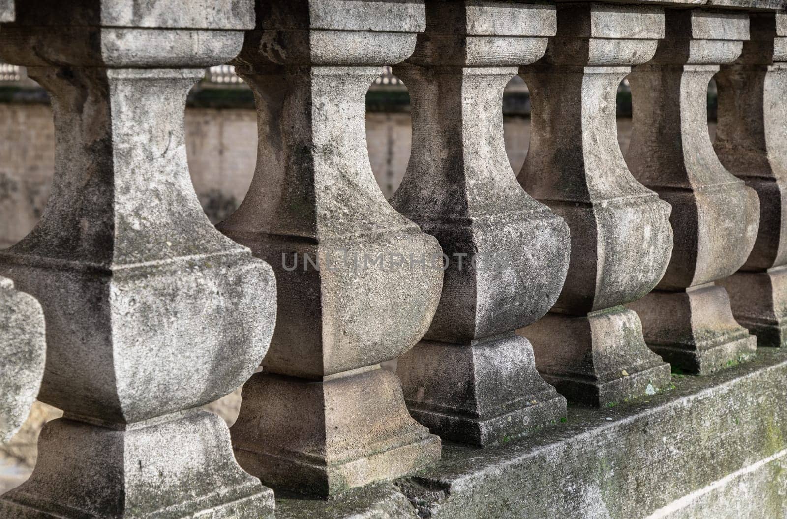 France, Paris - Jan 04, 2024 - Row of Old stone railings. Ancient architecture of Victorian stone balusters, Classical pillars supporting, Balustrade of stone columns, Space for text, Selective focus.
