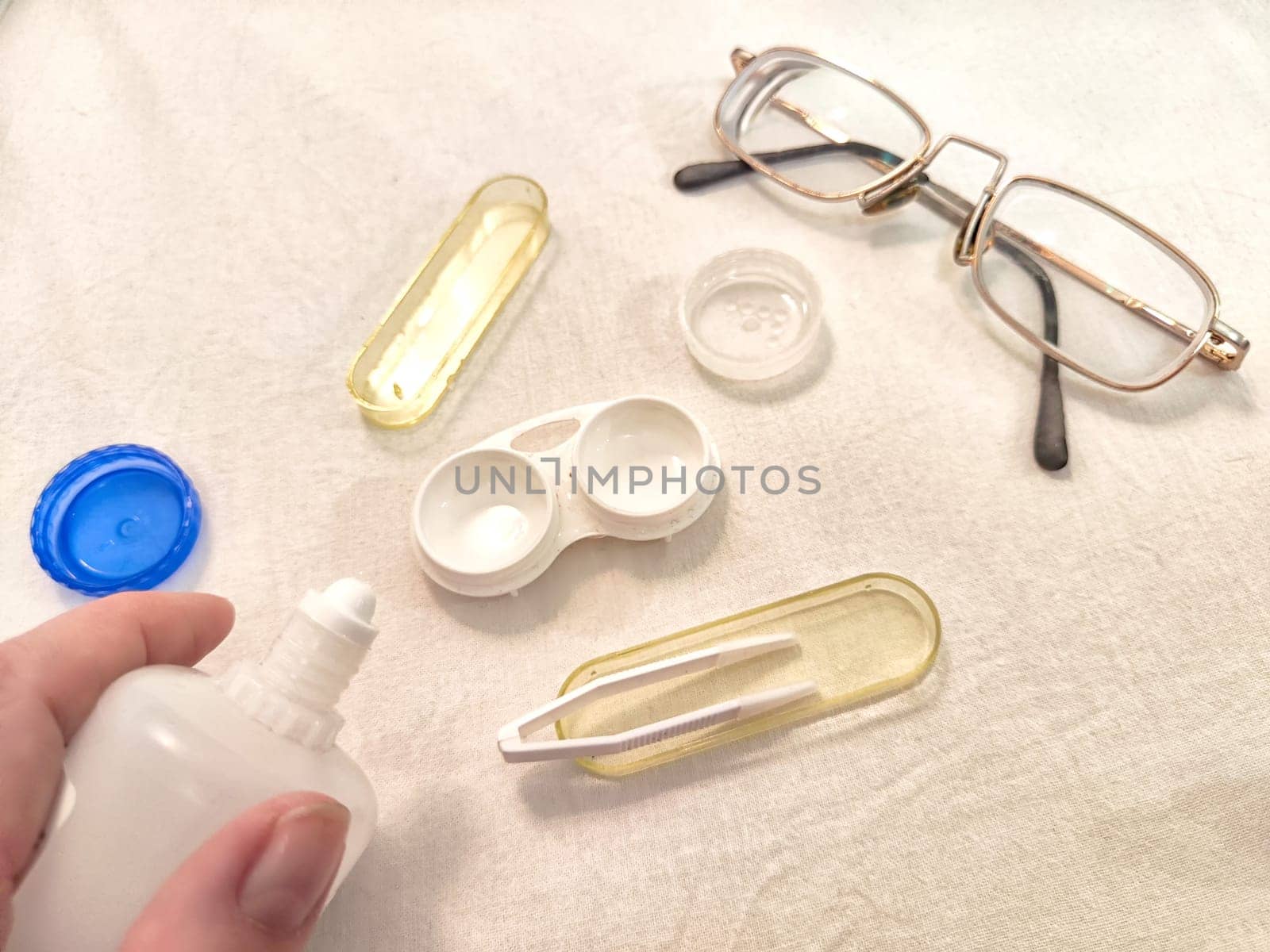 Set for contact lenses with a container, forceps, glasses. The concept of correcting myopia. Contact lens care, cleaning, health. Background, copy space