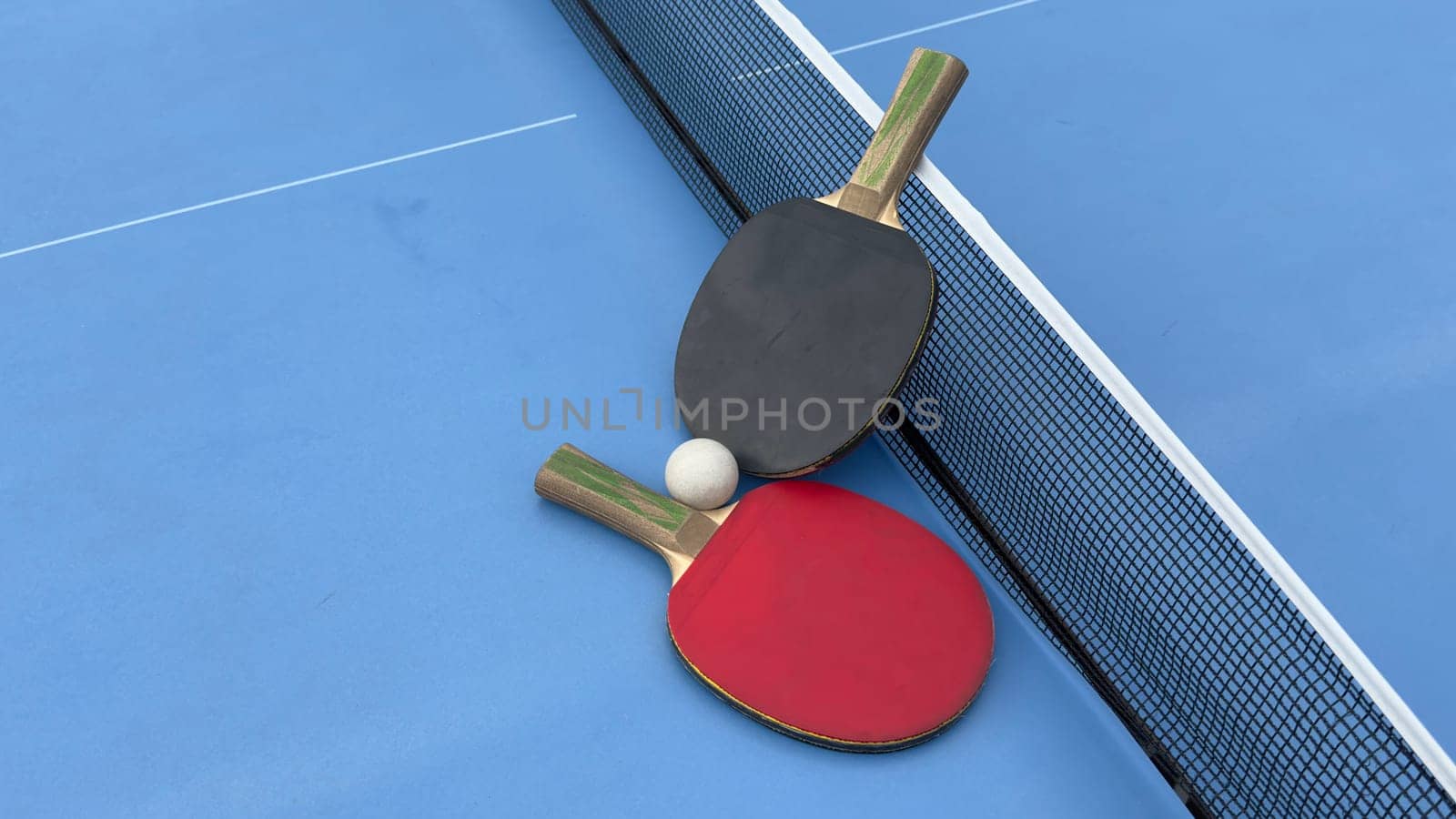 Table tennis rackets and ball on tennis table. High quality photo