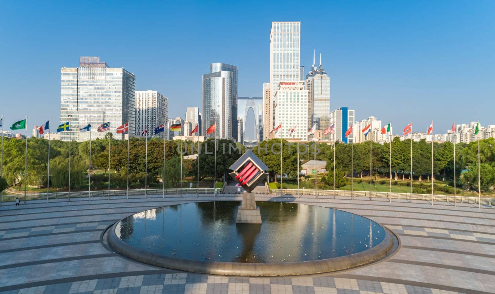 Suzhou, China - August 17, 2020: Aerial view of modern glass skyscrapers exterior with sunshine and reflection on the windows. Aerial over modern business office buildings, skyscrapers, financial district. by Busker