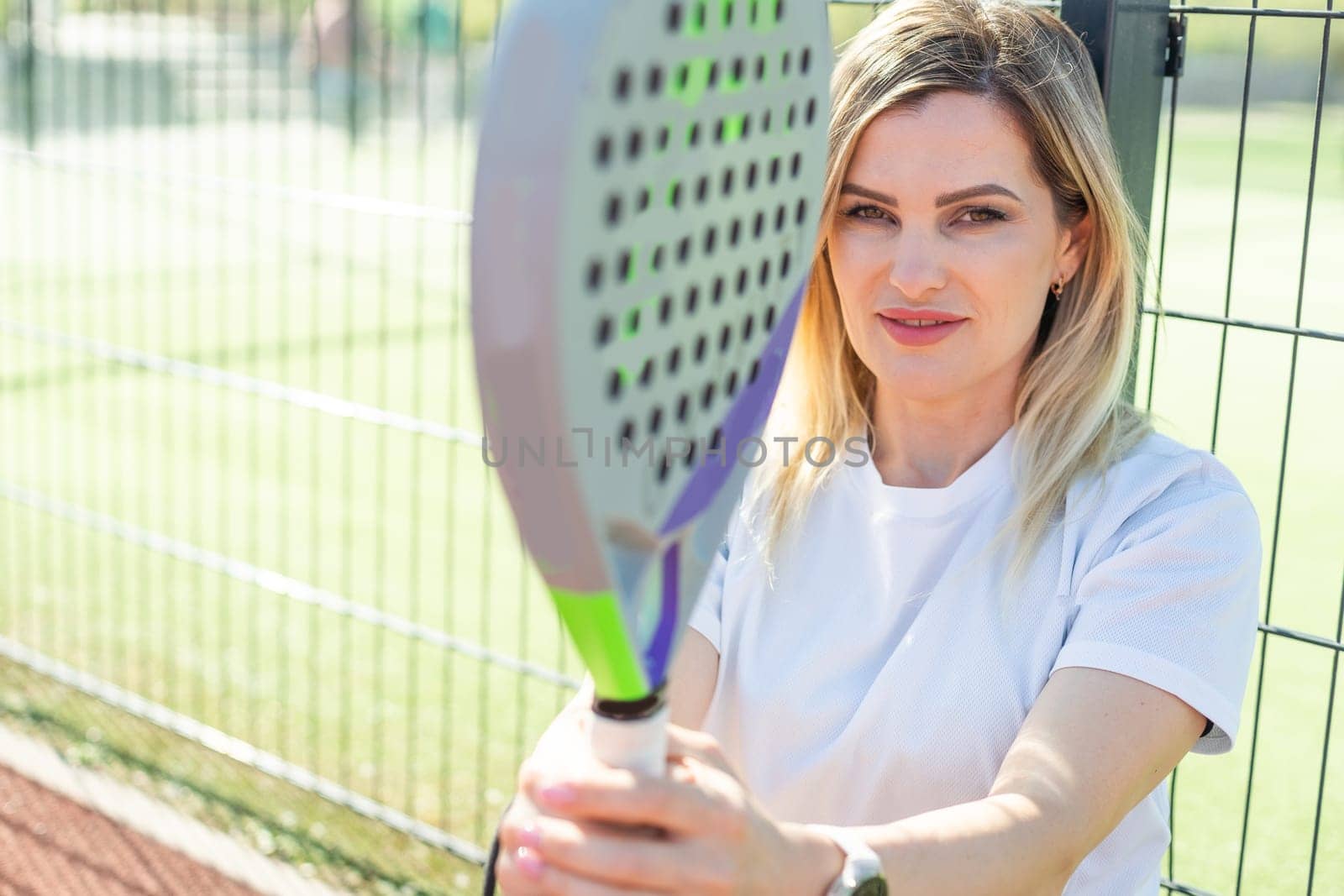 A female paddle tennis player after playing a match. High quality photo