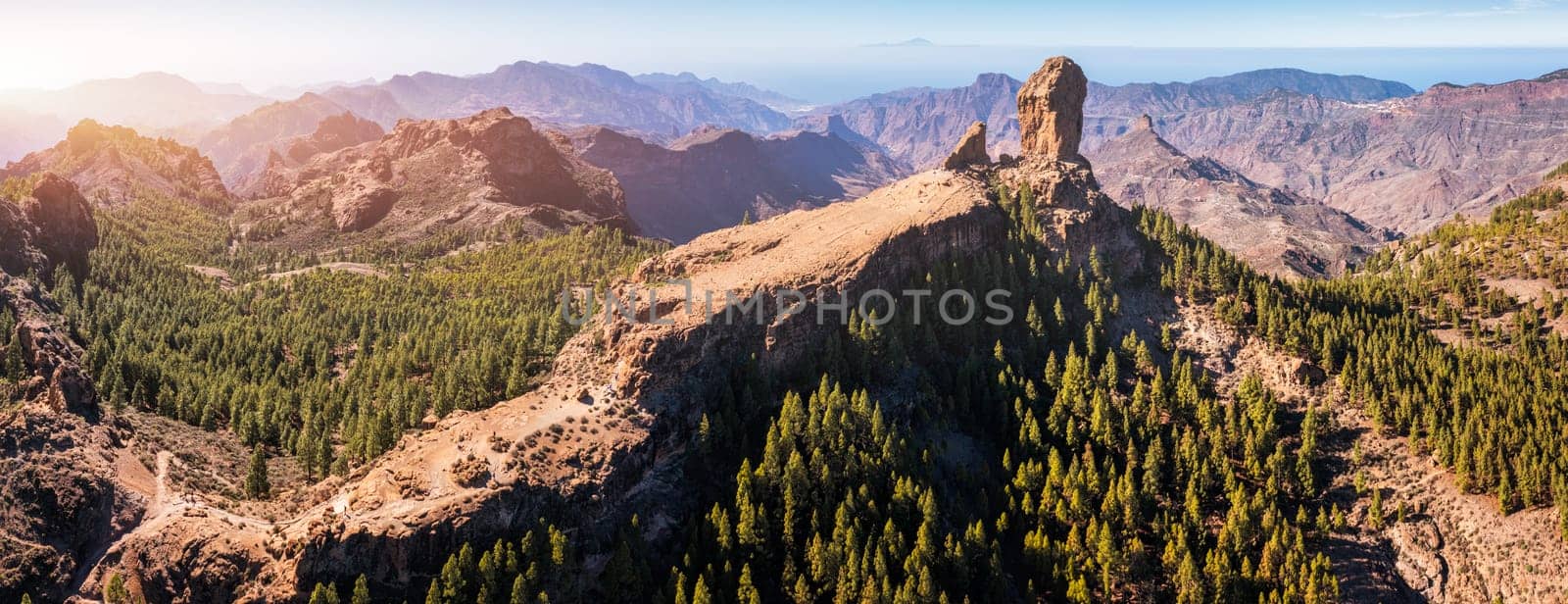 Roque Nublo and Pico de Teide in the background on Gran Canaria Island, Spain. Panoramic view of Roque Nublo sacred mountain, Roque Nublo Rural Park, Gran Canary, Canary Islands, Spain.