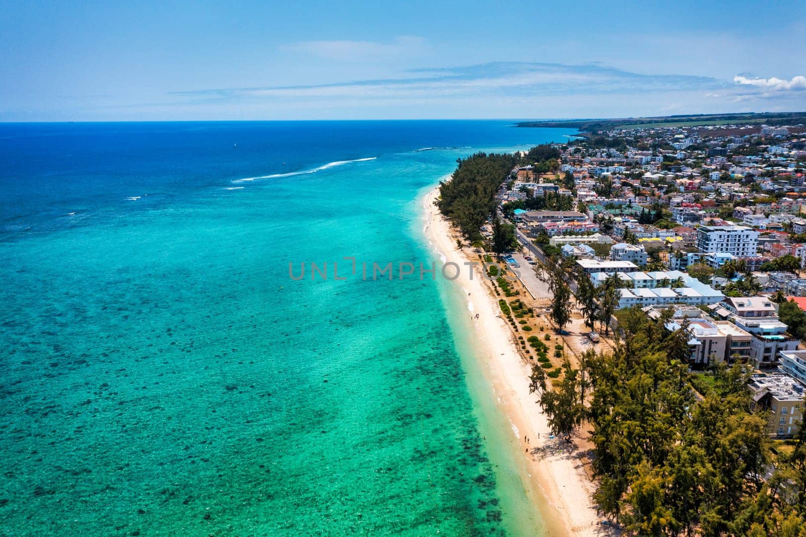 Beautiful Mauritius island with beach Flic en flac. Coral reef around tropical palm beach, Flic en Flac, Mauritius. Aerial view of a beautiful beach along the coast in Flic en Flac, Mauritius.