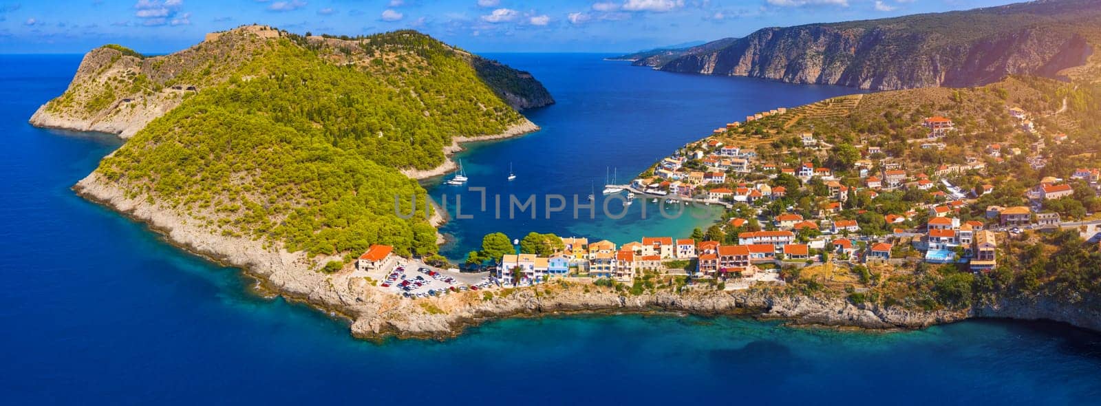 Assos village in Kefalonia, Greece. Turquoise colored bay in Mediterranean sea with beautiful colorful houses in Assos village in Kefalonia, Greece, Ionian island, Cephalonia, Assos village.