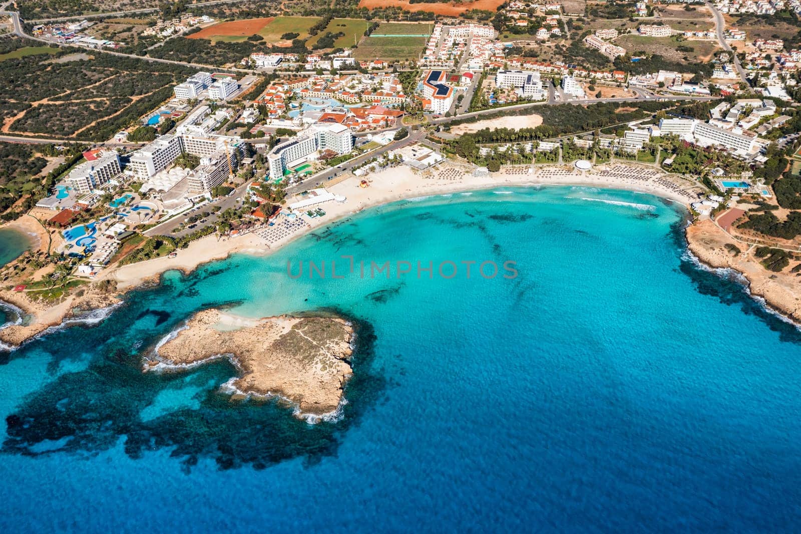 Aerial view of beautiful Nissi beach in Ayia Napa, Cyprus. Nissi beach in Ayia Napa famous tourist beach in Cyprus. A view of a azzure water and Nissi beach in Aiya Napa, Cyprus. by DaLiu