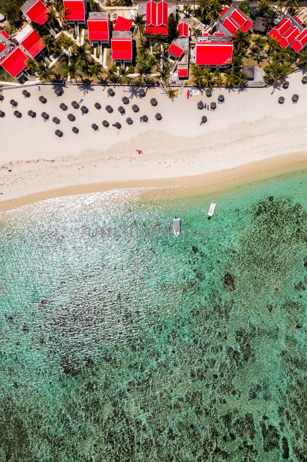 Beautiful Mauritius Island with gorgeous beach Flic en Flac, aerial view from drone. Mauritius, Black River, Flic-en-Flac view of oceanside village beach and luxurious hotel in summer.