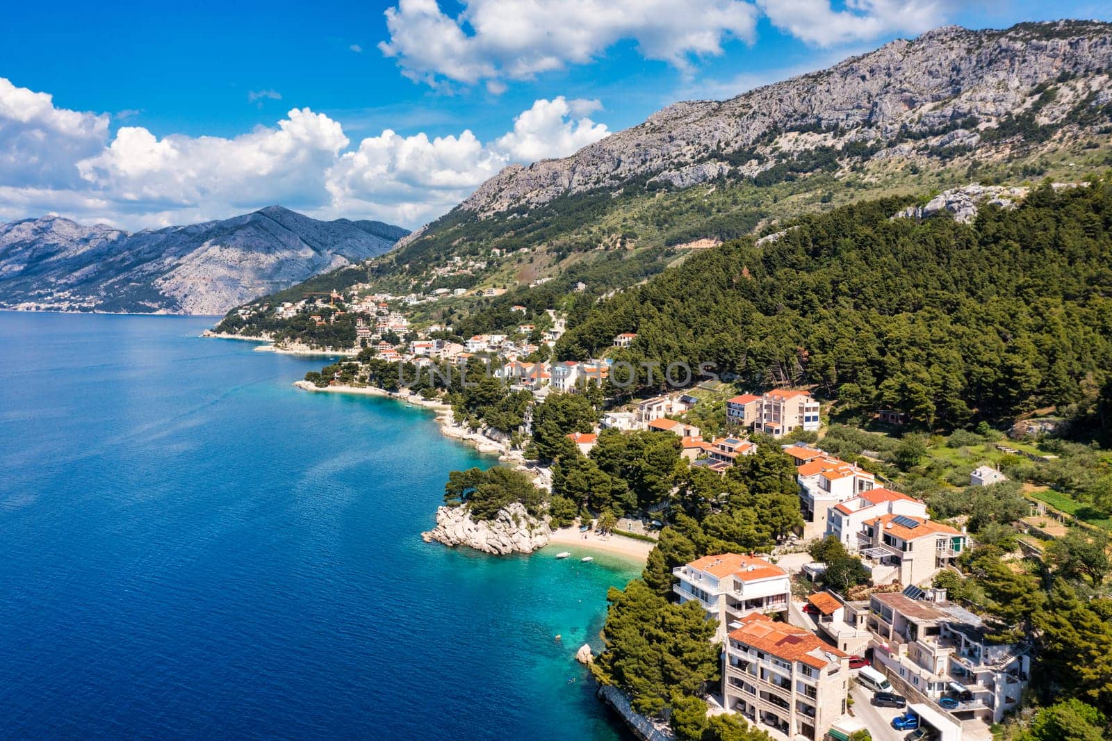 Beautiful Brela on Makarska riviera, Croatia. Adriatic Sea with amazing turquoise clean water and white sand. Aerial view of Brela town and waterfront on Makarska riviera, Dalmatia region of Croatia.